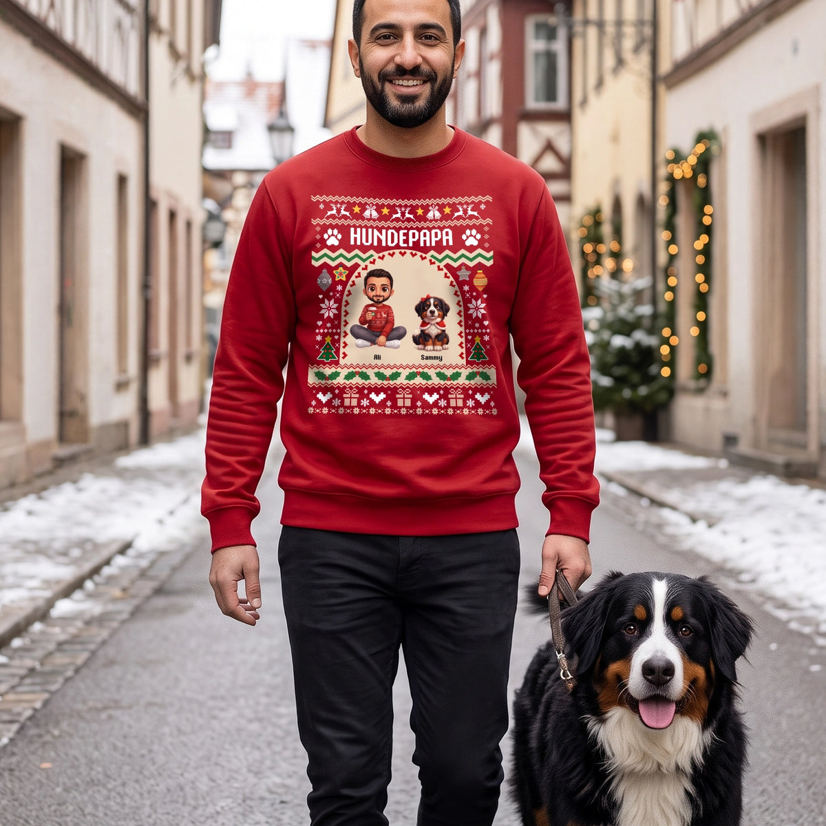 Mann im roten Sweater mit Schriftzug Hundepapa und Cartoon mit seinem Berner Sennenhund