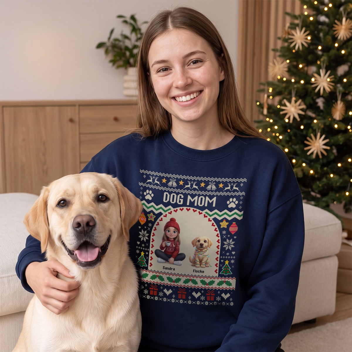 Frau im dunkelblauen Sweater mit Schriftzug Dog Mom neben ihrem Labrador